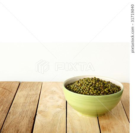 green beens are on wooden background. 31719840