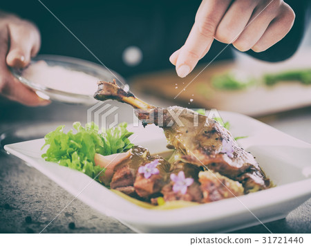The chef prepares a gourmet meal. 31721440