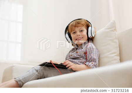 Sweet bright boy enjoying some music Sweet bright boy enjoying some music 31723216