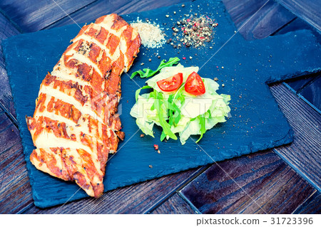 Grilled turkey fillet and vegetables in restaurant 31723396