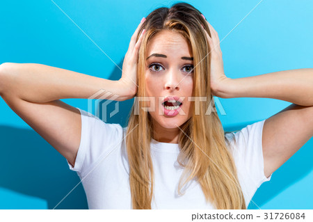 Young woman blocking her ears 31726084