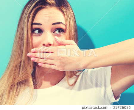 Young woman covering her mouth Young woman covering her mouth 31726085