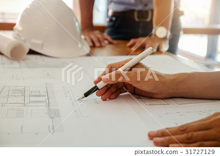 Architects engineer discussing at the table Architects engineer discussing at the table 31727129