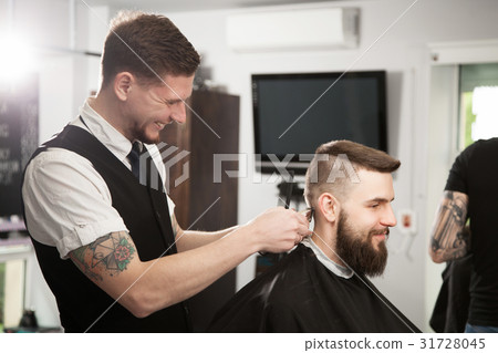 Professional barber doing a haircut Professional barber doing a haircut 31728045