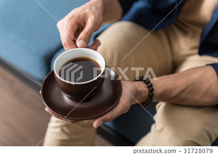 Youthful man spending time with favourite beverage 31728079