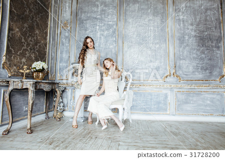 two pretty twin sister blond curly hairstyle girl 31728200