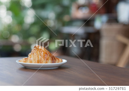 close-up croissant on white plate. close-up croissant on white plate. 31729781