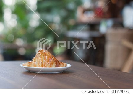 close-up croissant on white plate. 31729782