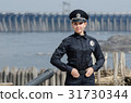 Cheerful female ukrainian police officer standing 31730344