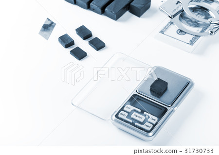 Blocks of hashish on digital scales over Blocks of hashish on digital scales over 31730733