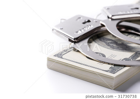 Pair of handcuffs closeup on dollar and euro Pair of handcuffs closeup on dollar and euro 31730738