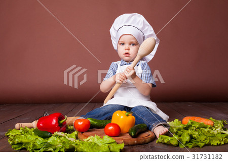 little boy Cook carrots, peppers, tomatoes little boy Cook carrots, peppers, tomatoes 31731182