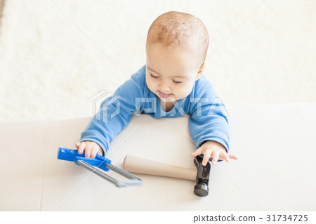 Baby with hammer intend to work 31734725