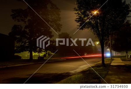 Apartment block on empty night city street  31734930