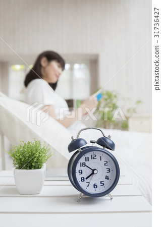 Woman reading lazily in the bedroom in the morning 31736427