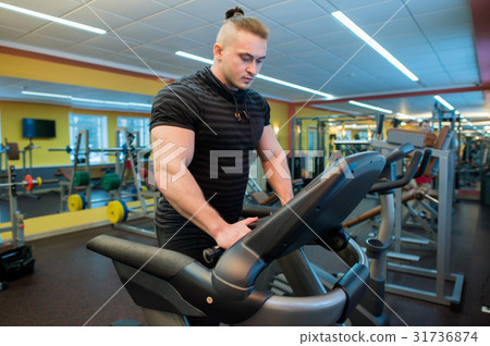 Attractive young muscular man while running on a Attractive young muscular man while running on a 31736874