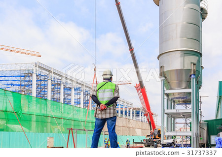 Supervisor holding walkie-talkie at construction Supervisor holding walkie-talkie at construction 31737337