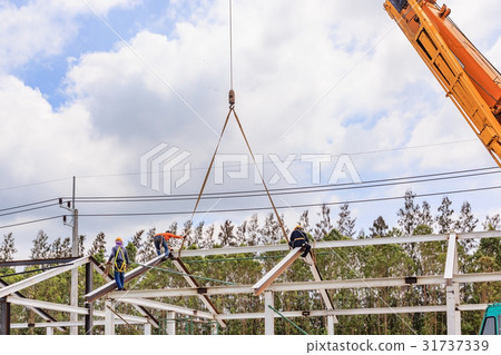 Worker working on steel roof structure on Worker working on steel roof structure on 31737339