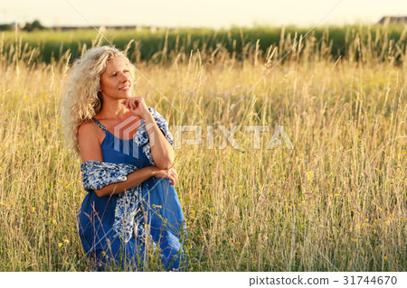 attractive mature woman in summer field 31744670
