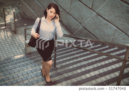 A woman ascending a staircase A woman ascending a staircase 31747048