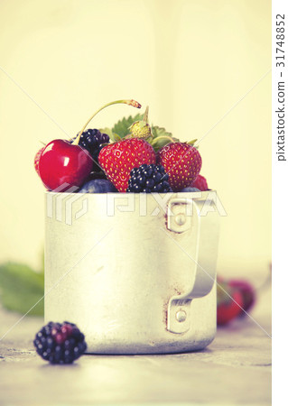 Berries in a rustic mug 31748852