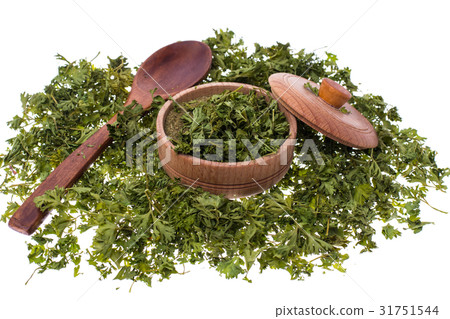 Dried and ground celery greens in a wooden jar Dried and ground celery greens in a wooden jar 31751544