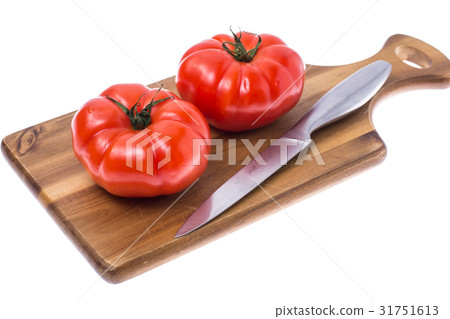 Red tomato on wooden board 31751613
