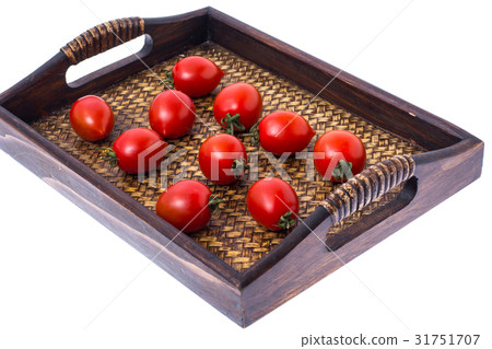 Brown wooden tray with small red tomatoes 31751707