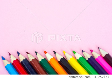 Multicolored pencils on pink paper background Multicolored pencils on pink paper background 31752137