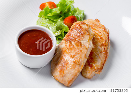 Grilled chicken fillets, chili pepper and tomatoes Grilled chicken fillets, chili pepper and tomatoes 31753295