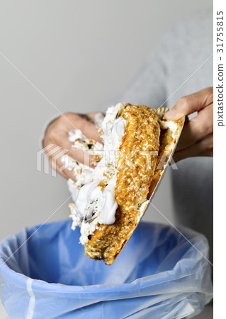 man throwing a cake to the trash bin 31755815