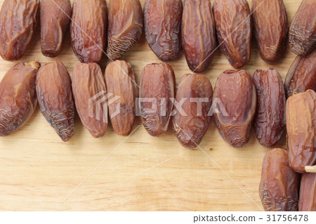 Dried date palm delicious on wood background. 31756478