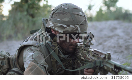 Sniper lying and aiming 31758095