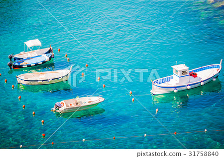 Beautiful cozy bay with boats and clear turquoise Beautiful cozy bay with boats and clear turquoise 31758840