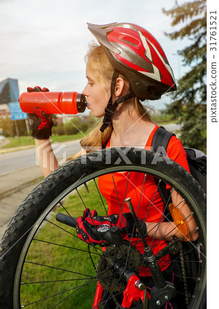 Bicycle tire pumping by child bicyclist. Girl Bicycle tire pumping by child bicyclist. Girl 31761521