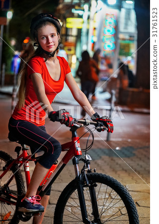 City night bicycle ride. Girls wearing bicycle City night bicycle ride. Girls wearing bicycle 31761523
