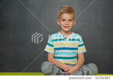 Boy posing with blackboard behind him Boy posing with blackboard behind him 31762867