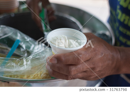 Scooping coconut Ice-cream on bread 31763798