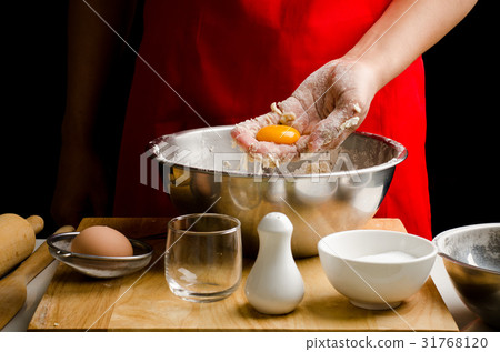 Egg yolk in hand for bread cooking 31768120