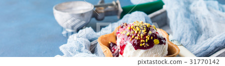 Vanilla ice cream scoops in waffle cup 31770142