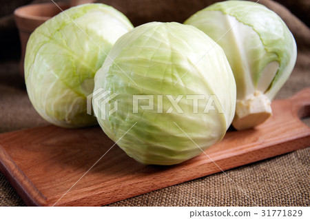 cabbage on a wooden board on a sacking, burlap cabbage on a wooden board on a sacking, burlap 31771829