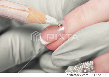 Closeup finger nail care by manicure specialist in 31772133