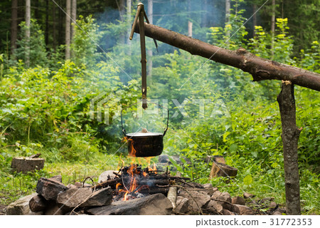 Cooking in caldron Cooking in caldron 31772353