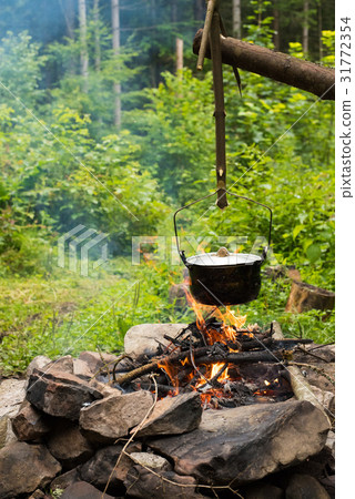 Cooking in caldron Cooking in caldron 31772354