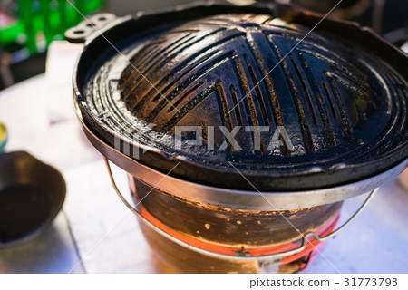 Hokkaido's specialty: Genghis Khan, a charcoal-grilled dish featuring a cast iron pot and fresh lamb. 31773793