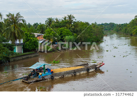 Wooden cargo boat on the Mekong River Delta Wooden cargo boat on the Mekong River Delta 31774462