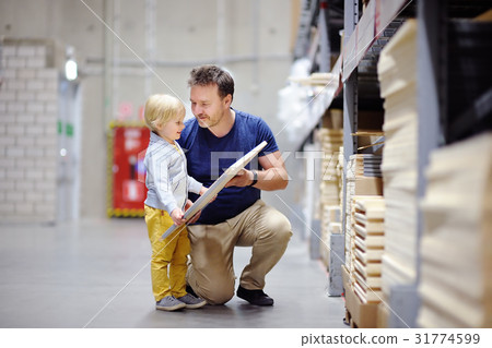 father with boy choosing the right furniture father with boy choosing the right furniture 31774599