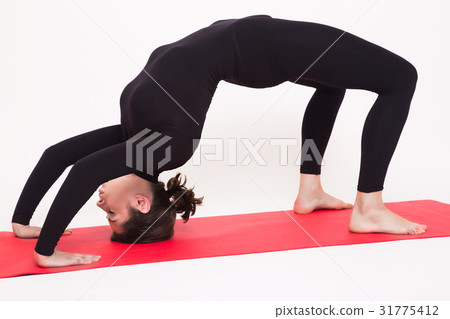 Beautiful athletic girl in black suit doing yoga Beautiful athletic girl in black suit doing yoga 31775412