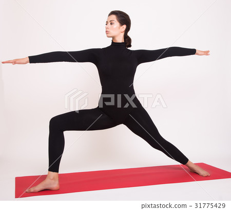 Beautiful athletic girl in black suit doing yoga Beautiful athletic girl in black suit doing yoga 31775429