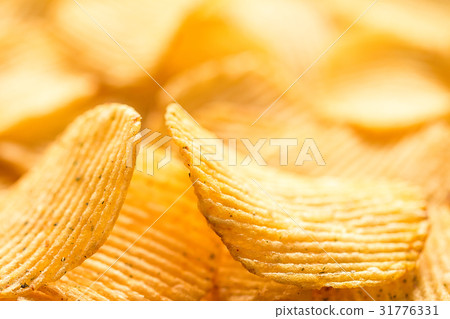 Yellow salted potato chips as background, closeup Yellow salted potato chips as background, closeup 31776331